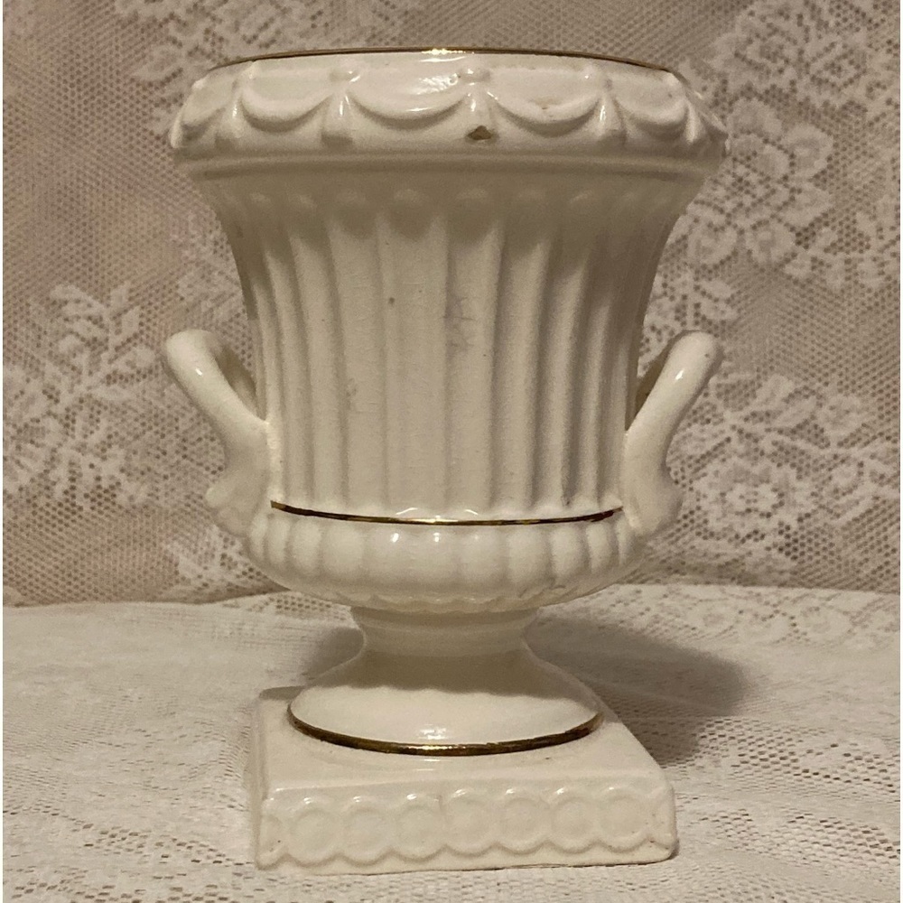 Vintage porcelain cream colored small urn with gold accents